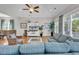 Bright living room boasts hardwood floors, large windows, and stylish, neutral-toned decor at 4989 Salt Creek Ct., North Myrtle Beach, SC 29582