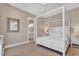 Main bedroom with a four-poster bed, soft carpet, and ensuite bathroom access at 4989 Salt Creek Ct., North Myrtle Beach, SC 29582