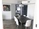 Dining area showcasing modern table and chairs, view into bedroom, and contemporary lighting at 7100 N Ocean Blvd. # 1023, Myrtle Beach, SC 29572
