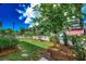 Serene backyard featuring a lush lawn, stepping stones, and a white picket fence, perfect for relaxation at 1348 Peterson St., Myrtle Beach, SC 29577