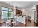 An elegant dining area features a glass table and chairs, with ample natural light streaming through the nearby window at 1348 Peterson St., Myrtle Beach, SC 29577