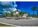 Beautifully landscaped home with a white picket fence, surrounded by lush greenery and a circular driveway at 1348 Peterson St., Myrtle Beach, SC 29577