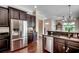 A kitchen features stainless steel refrigerator and dark wood cabinets, complemented by wood flooring at 1348 Peterson St., Myrtle Beach, SC 29577