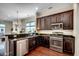 A spacious kitchen includes dark wood cabinets, stainless steel appliances, and a granite countertop at 1348 Peterson St., Myrtle Beach, SC 29577