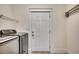 A well-lit laundry room equipped with modern appliances and a door leading outside at 1348 Peterson St., Myrtle Beach, SC 29577