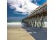 View of pier extending over ocean with sandy beach in foreground at 1348 Peterson St., Myrtle Beach, SC 29577