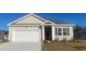 Charming single-story home featuring a garage and neatly landscaped front yard at 304 Glade Ct., Loris, SC 29569