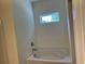 Soaking tub with chrome faucet and small window in a bright bathroom at 2275 King Farm Rd., Aynor, SC 29511