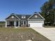 Exterior view of a well-maintained home, including an attached garage and green lawn at 2275 King Farm Rd., Aynor, SC 29511