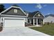 Charming single Gathering home showcasing an attached garage, stone accents, and manicured lawn at 2275 King Farm Rd., Aynor, SC 29511