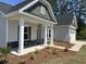 Covered porch displaying stone details and white pillars, leading to the home's entrance at 2275 King Farm Rd., Aynor, SC 29511