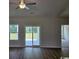 Bright living area with sliding glass doors to the backyard and stylish flooring at 2275 King Farm Rd., Aynor, SC 29511