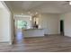 Open-concept living room with wood-look floors, kitchen island and stainless steel appliances at 2275 King Farm Rd., Aynor, SC 29511