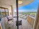 Spacious balcony with chairs and a table, offering beautiful views of the surrounding landscape and blue sky at 9650 Shore Dr. # 1906, Myrtle Beach, SC 29572