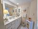 A well-lit bathroom offers a large mirror and cabinets, providing ample storage and a clean aesthetic at 9650 Shore Dr. # 1906, Myrtle Beach, SC 29572