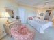 Cozy bedroom featuring a comfortable bed, a quaint chair, and a classic wooden dresser with mirror at 9650 Shore Dr. # 1906, Myrtle Beach, SC 29572