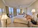 Bright bedroom featuring balcony access, floral patterns, and a ceiling fan at 9650 Shore Dr. # 1906, Myrtle Beach, SC 29572
