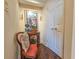 Elegant hallway adorned with a decorative side table, an upholstered chair and classic artwork and wall sconces at 9650 Shore Dr. # 1906, Myrtle Beach, SC 29572