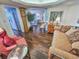 Bright sitting room showcasing daybed, vintage chair, wooden dresser, and hardwood flooring at 9650 Shore Dr. # 1906, Myrtle Beach, SC 29572