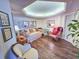 Cozy sitting room features a daybed, comfortable chairs, decorative mirrors, and wood flooring at 9650 Shore Dr. # 1906, Myrtle Beach, SC 29572