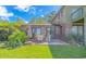 Lush backyard featuring a patio with a dining set and brick facade at 305 Resort Dr. # C12, Myrtle Beach, SC 29588