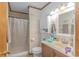 Bright bathroom with a wood-paneled accent wall, single vanity, and shower at 305 Resort Dr. # C12, Myrtle Beach, SC 29588