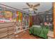 Eclectic bedroom with colorful wall art, a bed with canopy, and wood laminate floors at 305 Resort Dr. # C12, Myrtle Beach, SC 29588