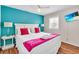 Stylish bedroom featuring a queen bed with a bright accent wall and natural light at 404 32Nd Ave. N, North Myrtle Beach, SC 29582
