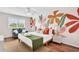 Bright bedroom featuring a queen bed, a sitting area, and a large, colorful floral mural at 404 32Nd Ave. N, North Myrtle Beach, SC 29582