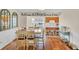 Dining area with hardwood floors, decorative mirrors, and an open view into the kitchen at 404 32Nd Ave. N, North Myrtle Beach, SC 29582