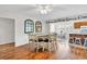 Bright dining room featuring hardwood floors and an open layout to the kitchen area at 404 32Nd Ave. N, North Myrtle Beach, SC 29582