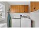 Efficient laundry area with side-by-side washer and dryer, plus storage cabinets at 404 32Nd Ave. N, North Myrtle Beach, SC 29582