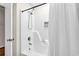 Full shower and bathtub combo with a white shower curtain and wall dispenser at 404 32Nd Ave. N, North Myrtle Beach, SC 29582