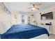 Bright bedroom featuring a queen size bed, ceiling fan, beach decor, and TV at 6000 N Ocean Blvd. # 330, North Myrtle Beach, SC 29582