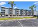Low-rise condos with ample parking and palm trees under a clear blue sky at 6000 N Ocean Blvd. # 330, North Myrtle Beach, SC 29582