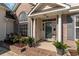 Charming brick home's front entrance featuring white columns, arched window, and potted plants adding curb appeal at 7270 Guinevere Circle, Myrtle Beach, SC 29588