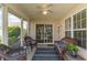 Relaxing screened porch with comfortable wicker furniture, ceiling fan, and views of the serene backyard at 7270 Guinevere Circle, Myrtle Beach, SC 29588