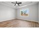 Bright bedroom with a large window and hardwood floors at 1409 Crooked Hook Rd., North Myrtle Beach, SC 29582