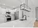 Modern kitchen with white cabinets, quartz countertops and stainless steel appliances at 1409 Crooked Hook Rd., North Myrtle Beach, SC 29582
