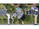 Aerial view of an estate featuring a pool, meticulously landscaped grounds, and surrounding trees at 9318 Cove Dr., Myrtle Beach, SC 29572