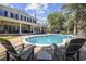 Stunning backyard pool with brick surround, lounge chairs, and a view of the elegant home at 9318 Cove Dr., Myrtle Beach, SC 29572