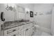 Stylish bathroom featuring a white vanity with a granite countertop and decorative fixtures at 9318 Cove Dr., Myrtle Beach, SC 29572