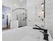 Bright bathroom featuring white shiplap walls, a soaking tub, and glass enclosed shower at 9318 Cove Dr., Myrtle Beach, SC 29572