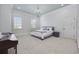 Bright bedroom featuring a gray bed, two windows, and a chandelier at 9318 Cove Dr., Myrtle Beach, SC 29572