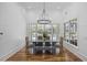 Dining room features shiplap walls, a modern chandelier, and views of the outdoor pool at 9318 Cove Dr., Myrtle Beach, SC 29572