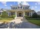 Stunning two-story white brick home with large columns and professionally landscaped front yard at 9318 Cove Dr., Myrtle Beach, SC 29572