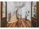 Grand foyer with wood floors, high ceilings, elegant staircase, and decorative lighting fixture at 9318 Cove Dr., Myrtle Beach, SC 29572