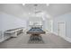 Spacious game room featuring a shuffleboard table, pool table, and large windows at 9318 Cove Dr., Myrtle Beach, SC 29572