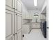 Laundry room features white cabinets, a window, and modern appliances at 9318 Cove Dr., Myrtle Beach, SC 29572