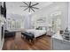 Bright main bedroom with hardwood floors, plantation shutters, and a cozy sitting area at 9318 Cove Dr., Myrtle Beach, SC 29572